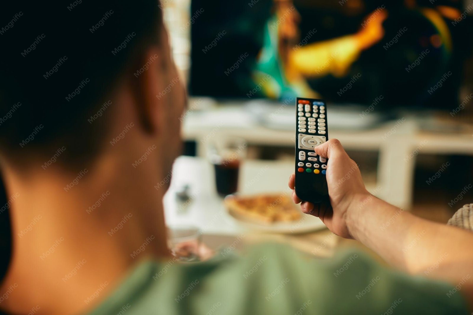 Close-up of a man watching television at home