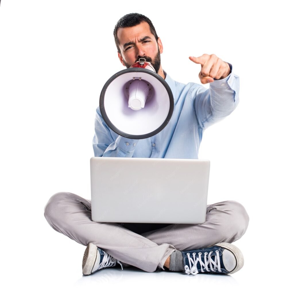 A man with a laptop shouting through a megaphone