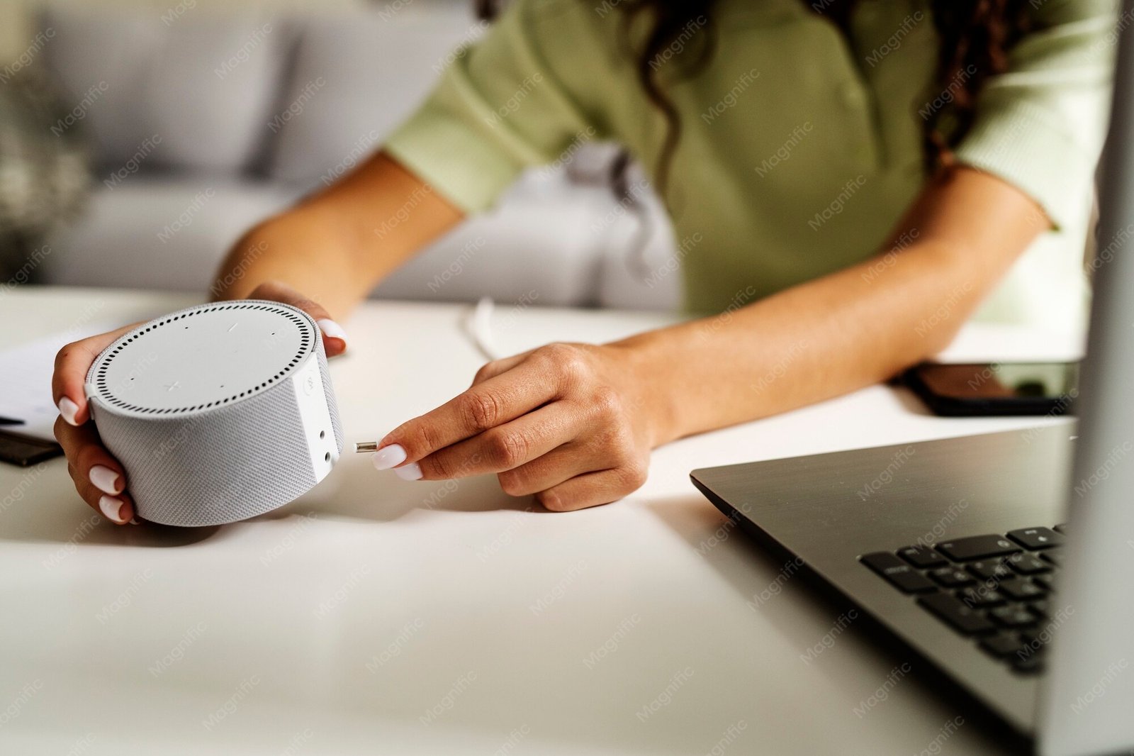 Side view of a woman holding a smart speaker