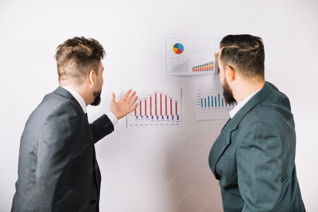 Colleagues looking at charts and diagrams on a wall