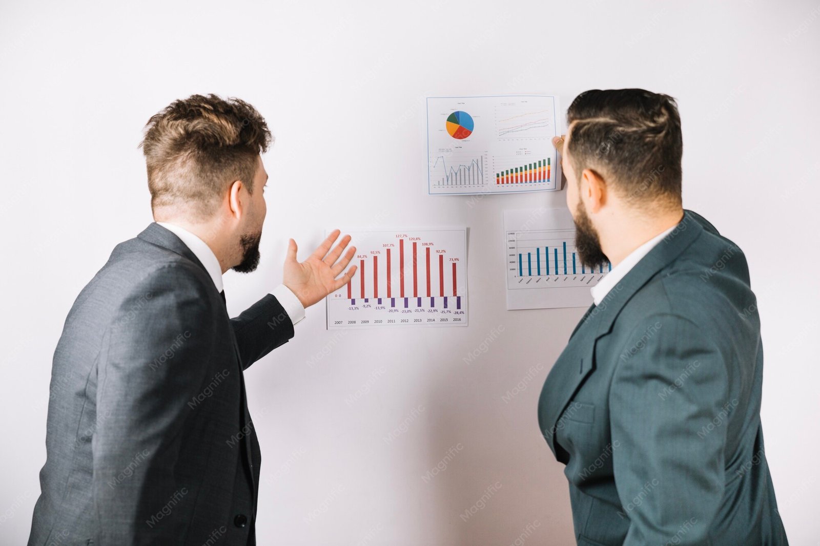 Colleagues looking at charts and diagrams on a wall
